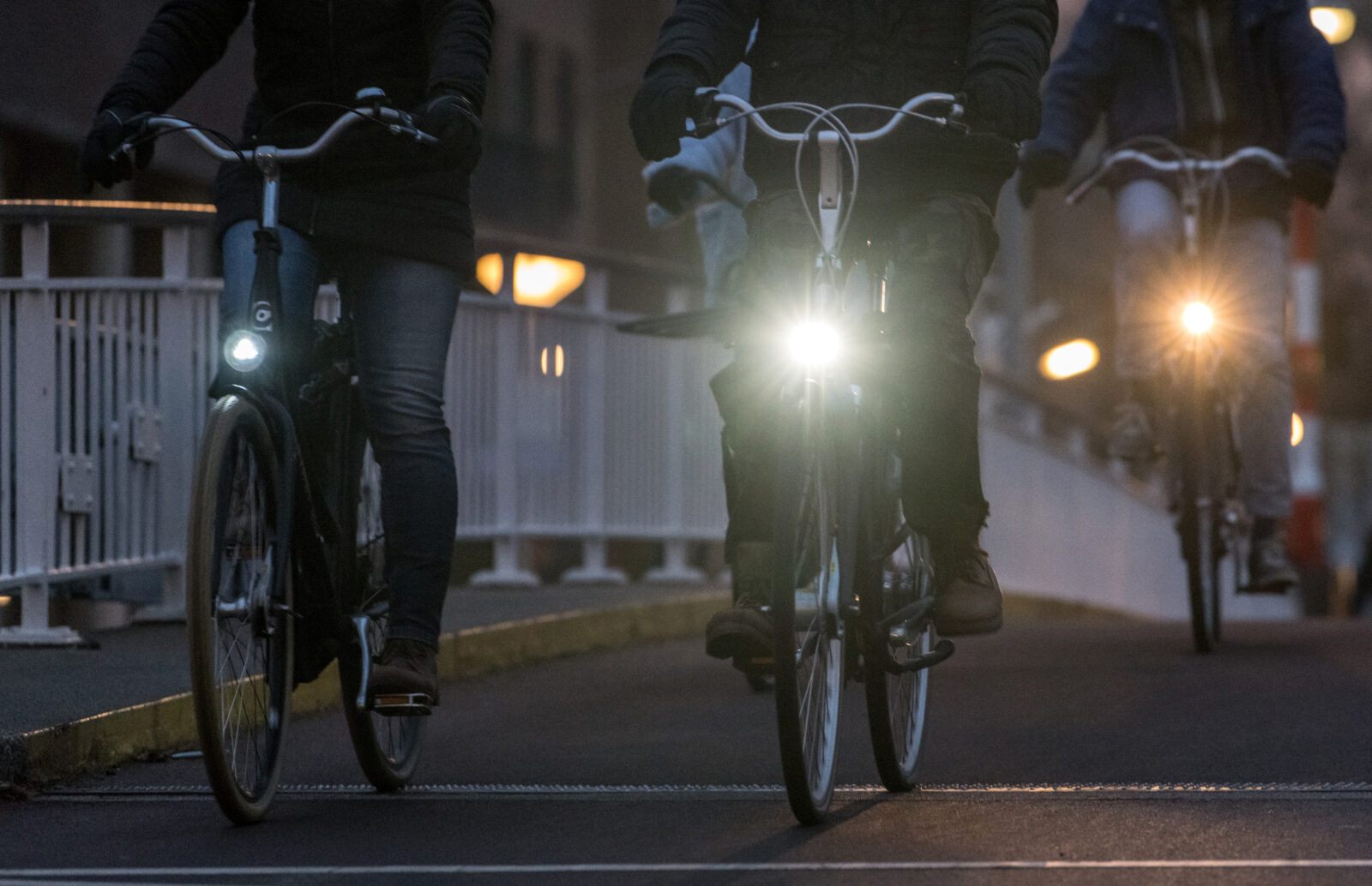 Fietsers in het donker met brandende koplampen.