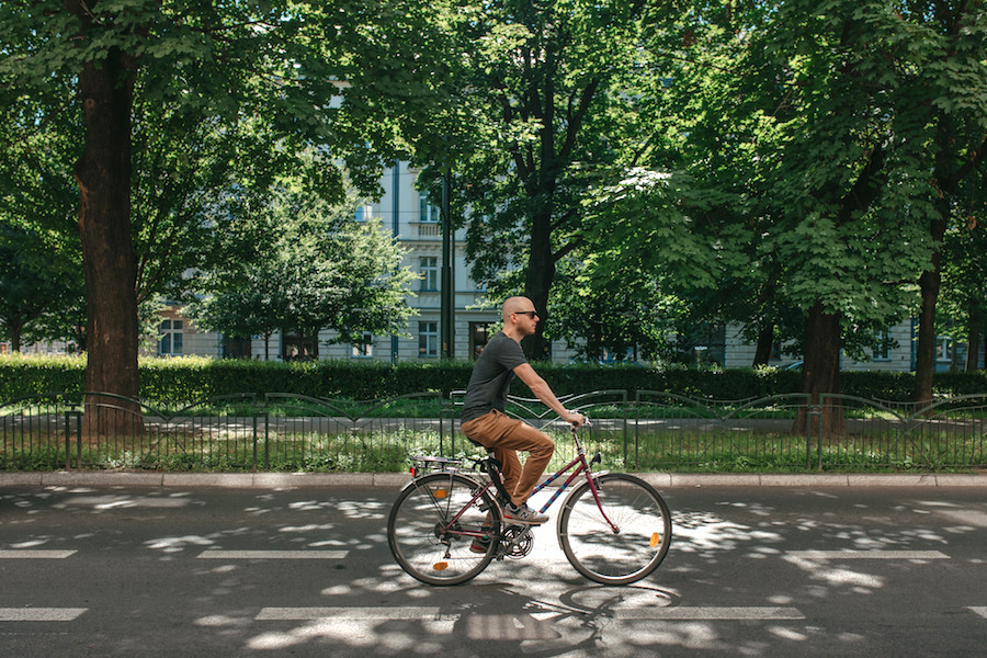 Journalist Dennis de Vries fietst over de vergroende Krupniczastraat in Krakau.