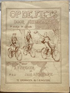Omslag van het boekje Op de fiets door Nederland met een tekening van de twee hoofdpersonen en hun meester.